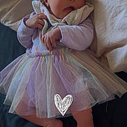 Zena joined the competition — help win amazing prizes! baby, infant, tulle_skirt, purple_clothing, blanket, bed, sheet, soft_toy, hand, foot, face, newborn, cute, lying_down, indoors, natural_light, fabric, skin, sleepwear, expression