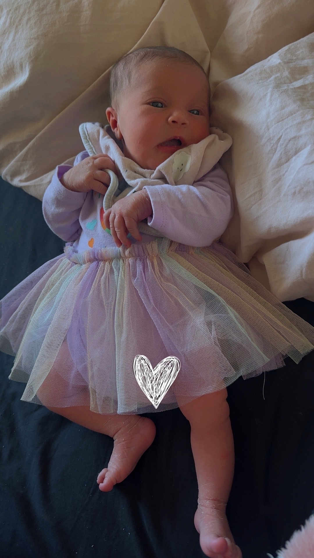 Zena joined the competition — help win amazing prizes! baby, infant, tulle_skirt, purple_clothing, blanket, bed, sheet, soft_toy, hand, foot, face, newborn, cute, lying_down, indoors, natural_light, fabric, skin, sleepwear, expression