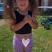 Malake joined the competition — help win amazing prizes! backyard, barefoot, black_top, child, clothing, cute, daylight, girl, grass, happy, outdoor, pigtails, playful, portrait, shorts, smiling, summer, sunny, toy_tricycle, yellow_bows