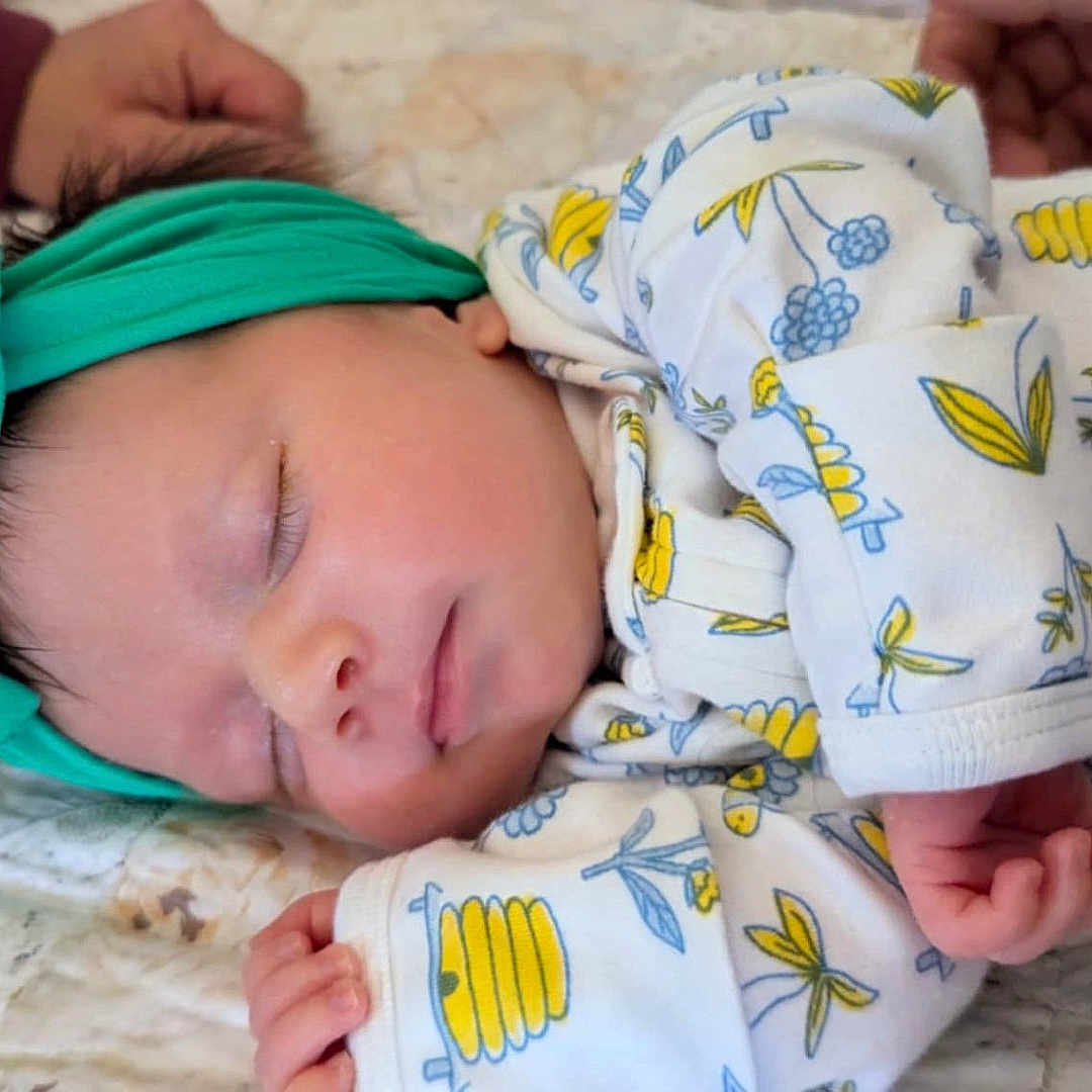 Elaina joined the competition — help win amazing prizes! architecture, baby, bed, blanket, bonnet, building, clothing, cushion, face, furniture, glove, hat, head, homedecor, newborn, person, photography, portrait, quilt, sleeping