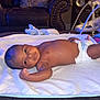 Kaleb joined the competition — help win amazing prizes! arm, baby, blanket, child, comfort, cushion, diaper, face, floor, furniture, head, home, infant, leg, living_room, lying_down, relaxing, skin, smiling, sofa