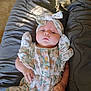 Natalie joined the competition — help win amazing prizes! baby, infant, child, floral_outfit, headband, blanket, gray_blanket, lying_down, portrait, cute, young_child, soft_lighting, indoors, comfortable, hands, face, expressionless, cozy, clothing, resting