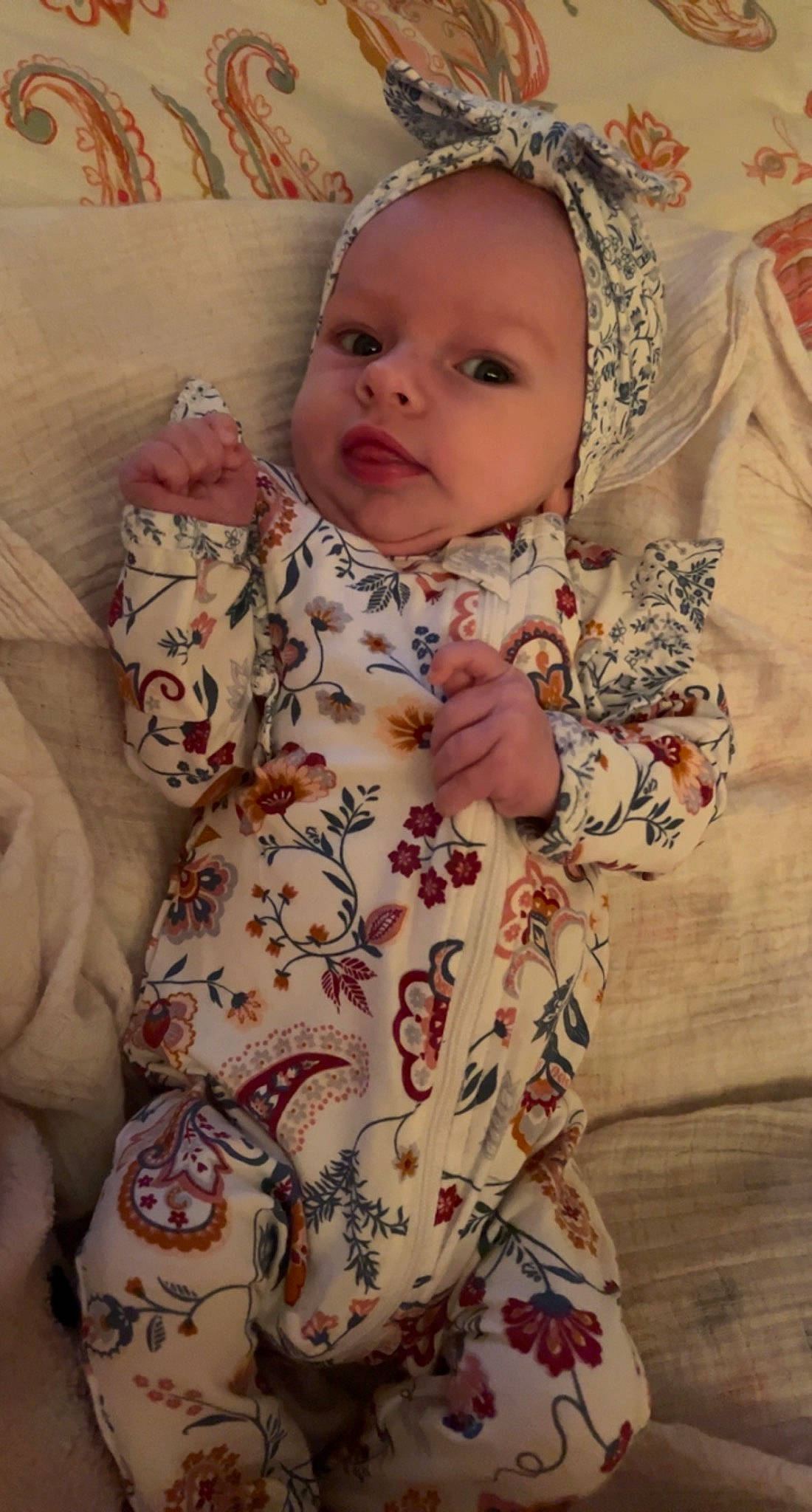 Alia is registered to the contest to win money with this photo: baby, baby_toddler_clothing, cheek, child, comfort, dress, eye, face, head, linens, lip, mammal, organ, outerwear, pattern, person, pink, skin, sleeve, textile