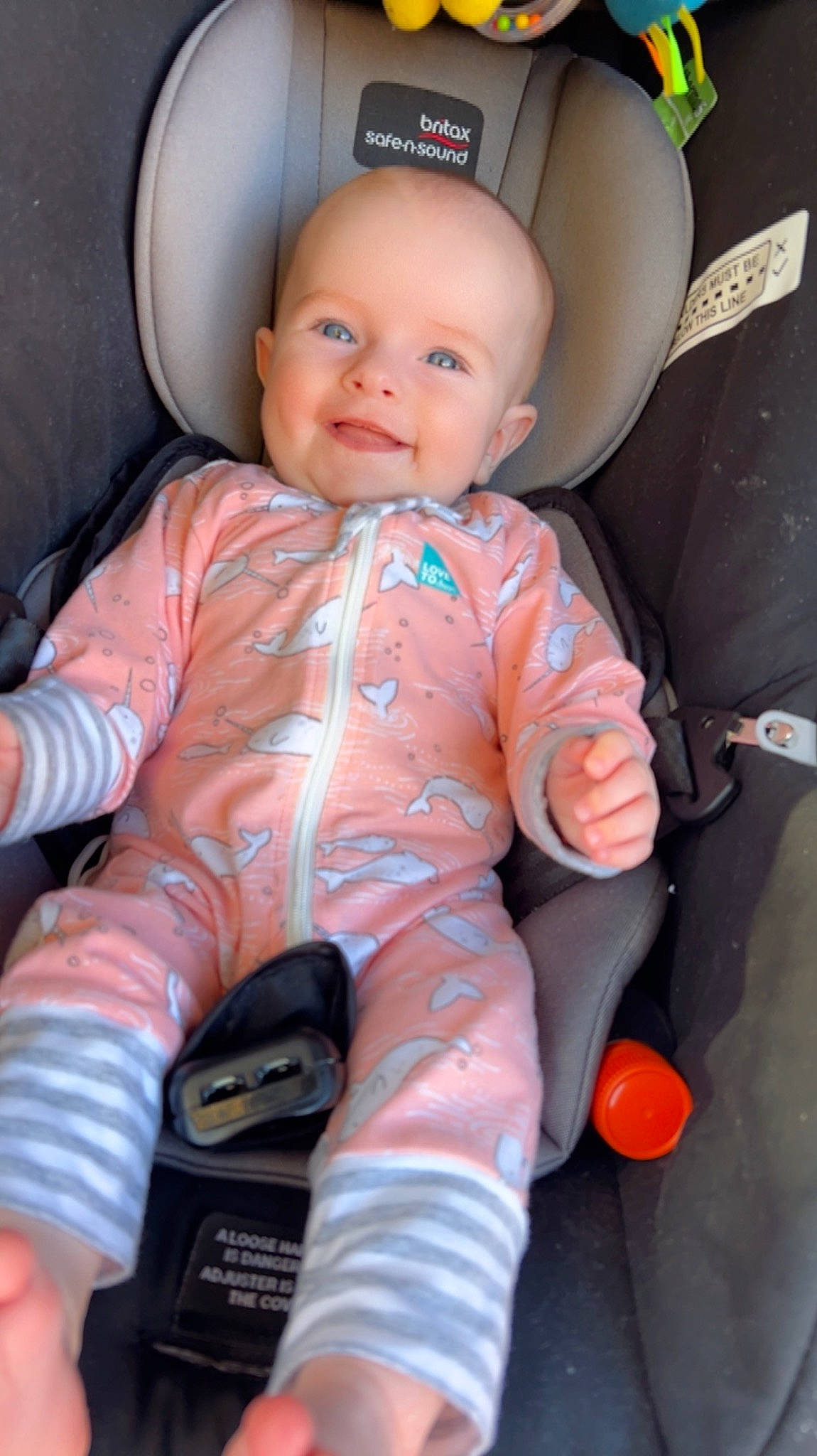 Alia is registered to the contest to win money with this photo: arm, baby, baby_toddler_clothing, cheek, child, chin, comfort, cool, eye, finger, fun, head, joy, nose, orange, organ, person, pink, skin, smile