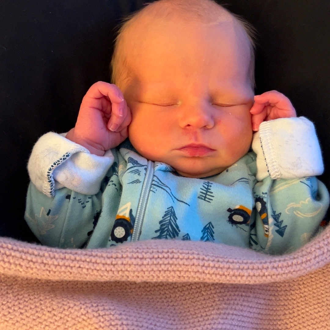 Macalister is registered to the contest to win money with this photo: baby, bed, blanket, bodypart, clothing, couch, crib, cushion, face, finger, furniture, hand, hat, head, homedecor, newborn, person, photography, portrait, sleeping