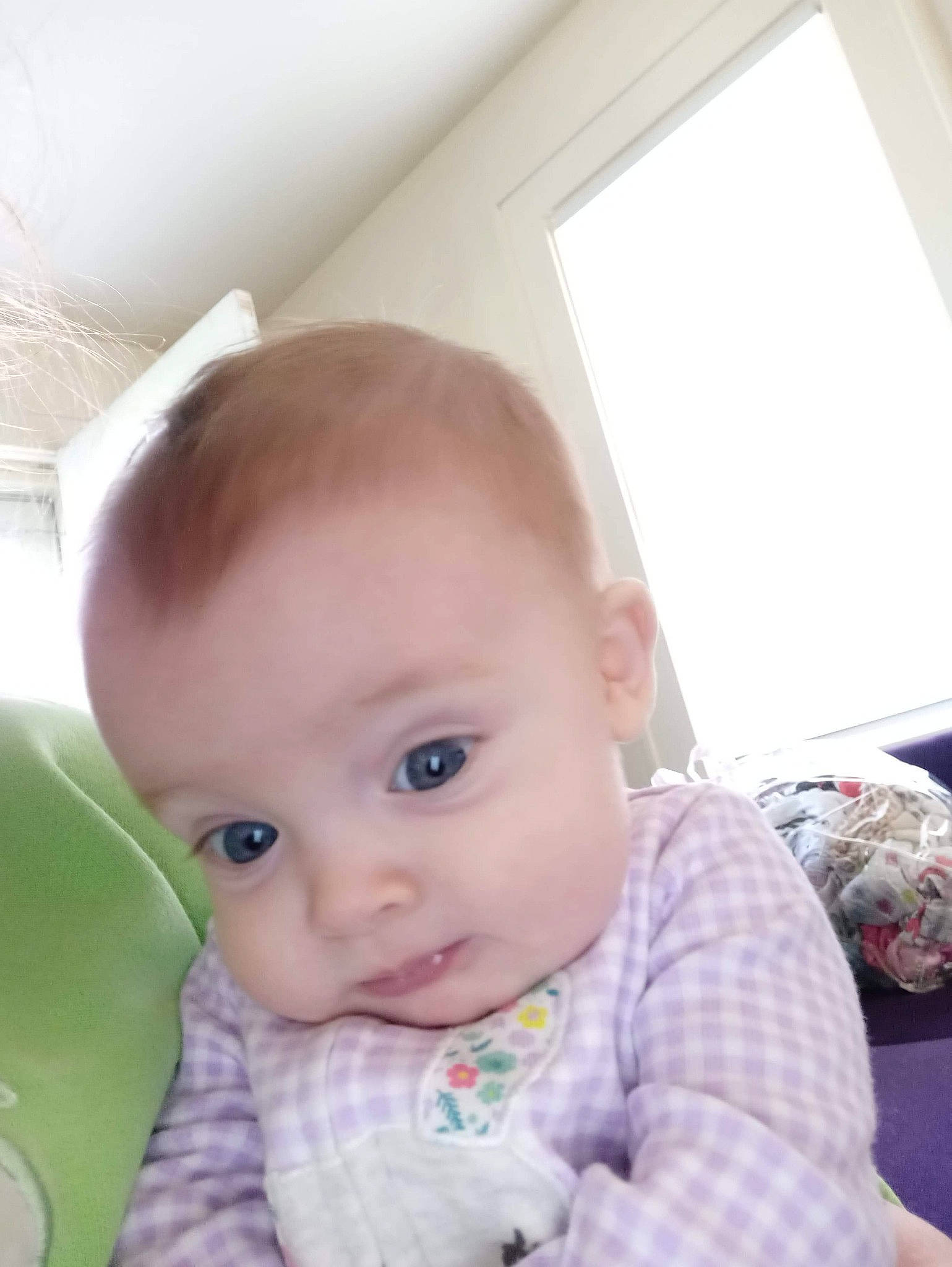 Evelyn joined the competition — help win amazing prizes! baby, baby_toddler_clothing, cheek, child, chin, comfort, ear, eye, eyelash, flooring, fun, iris, lip, nose, person, sitting, skin, sleeve, smile, toddler