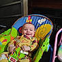 baby, smiling, child, indoor, fisher_price, baby_chair, colorful, seated, happy, clothing, face, infant, furniture, toy, cushion, person, young_child, home, playtime, comfort