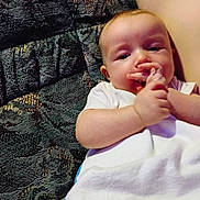 Noah joined the competition — help win amazing prizes! baby, infant, blanket, couch, texture, hand, face, skin, white_clothing, curious, indoors, child, young, resting, comfort, cute, portrait, small_hands, relaxed, cozy