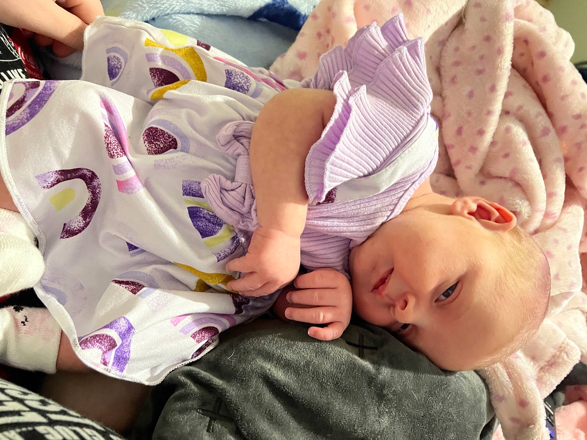 Kairi is registered to the contest to win money with this photo: arm, baby, baby_sleeping, baby_toddler_clothing, cheek, child, comfort, eyelash, finger, hairstyle, hand, happy, linens, mouth, nail, neck, person, purple, skin, thigh