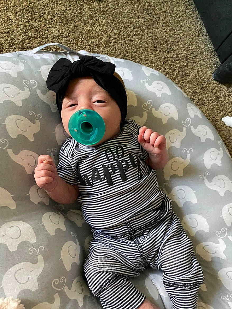 Kaelanii is registered to the contest to win money with this photo: baby, baby_products, baby_safety, baby_toddler_clothing, cheek, child, comfort, fun, grass, infant_bodysuit, linens, pattern, person, personal_protective_equipment, sitting, skin, sleeve, toddler