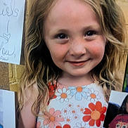 Caia joined the competition — help win amazing prizes! child, girl, smile, freckles, floral_dress, long_hair, blonde_hair, portrait, closeup, corkboard, pinned_photo, wall, happy, cheeks, eyes, cute, youth, summer_dress, photograph, face