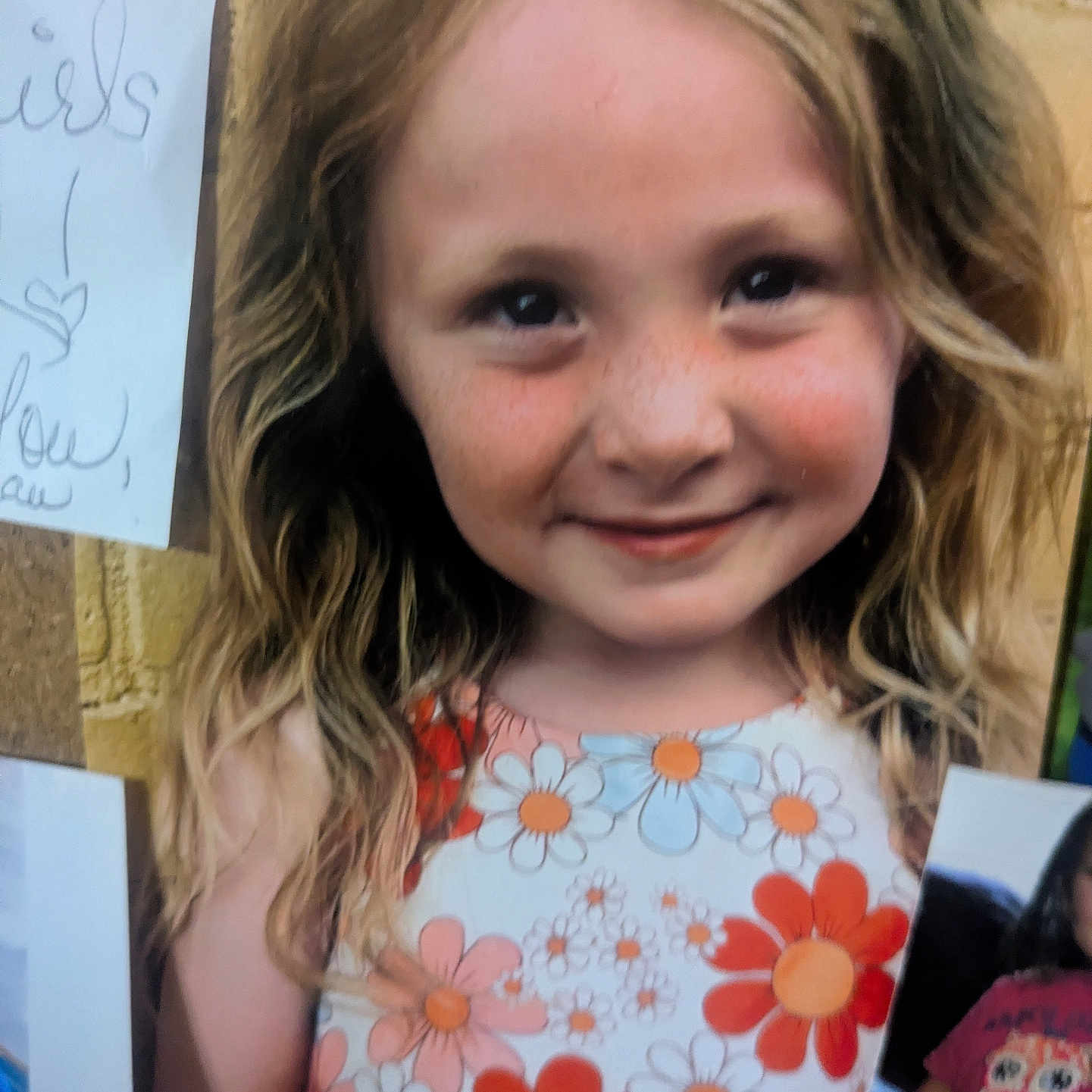 Caia joined the competition — help win amazing prizes! blonde_hair, cheeks, child, closeup, corkboard, cute, eyes, face, floral_dress, freckles, girl, happy, long_hair, photograph, pinned_photo, portrait, smile, summer_dress, wall, youth