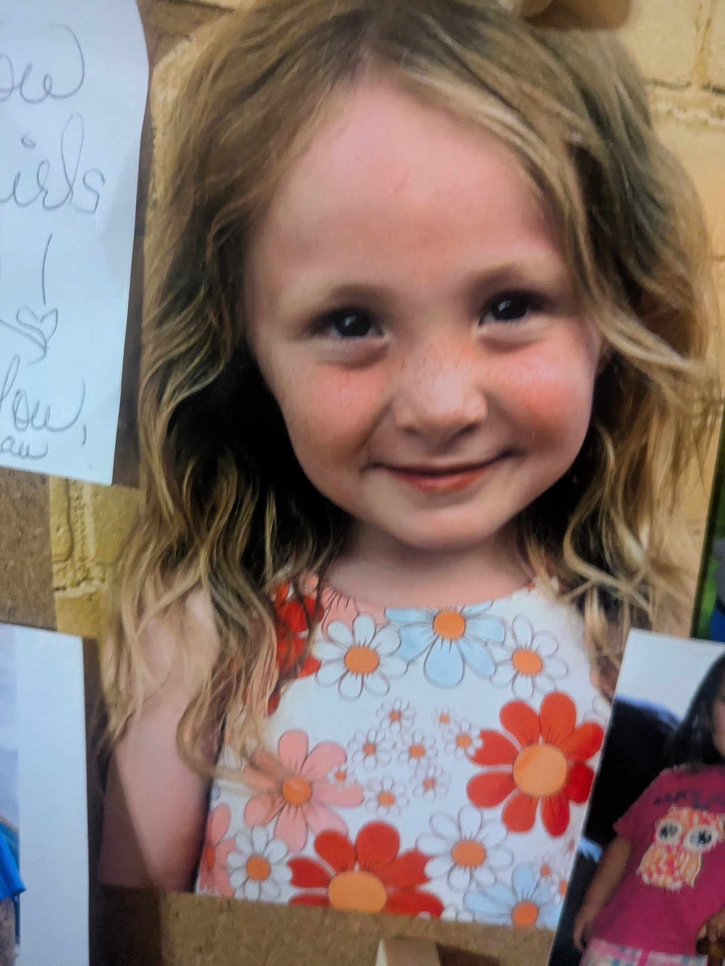 Caia joined the competition — help win amazing prizes! child, girl, smile, freckles, floral_dress, long_hair, blonde_hair, portrait, closeup, corkboard, pinned_photo, wall, happy, cheeks, eyes, cute, youth, summer_dress, photograph, face