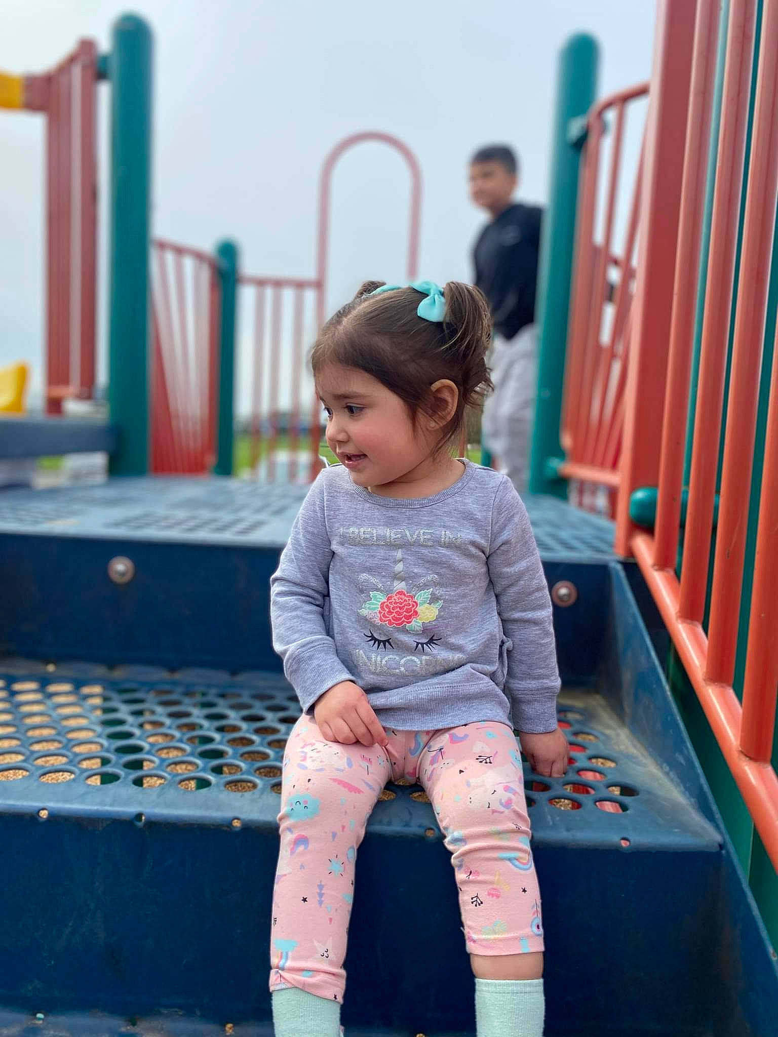 Elena is registered to the contest to win money with this photo: baby_toddler_clothing, blurred, child, denim, electric_blue, fun, happy, human_leg, jeans, leisure, magenta, pattern, person, play, recreation, red, sitting, sky, t_shirt, thigh