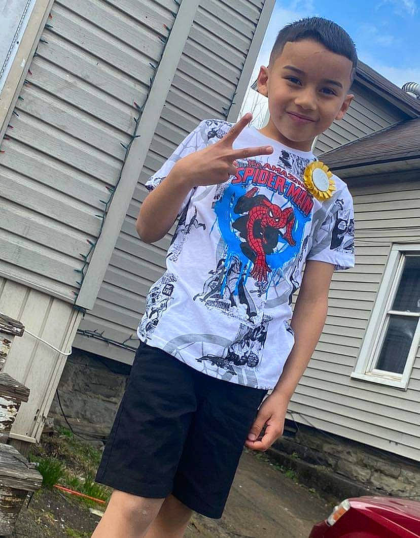 Jesus is registered to the contest to win money with this photo: board_short, child, cool, denim, electric_blue, fashion_design, hairstyle, happy, joy, leisure, magenta, person, plant, shoulder, sleeve, smile, sportswear, t_shirt, thigh, trunk