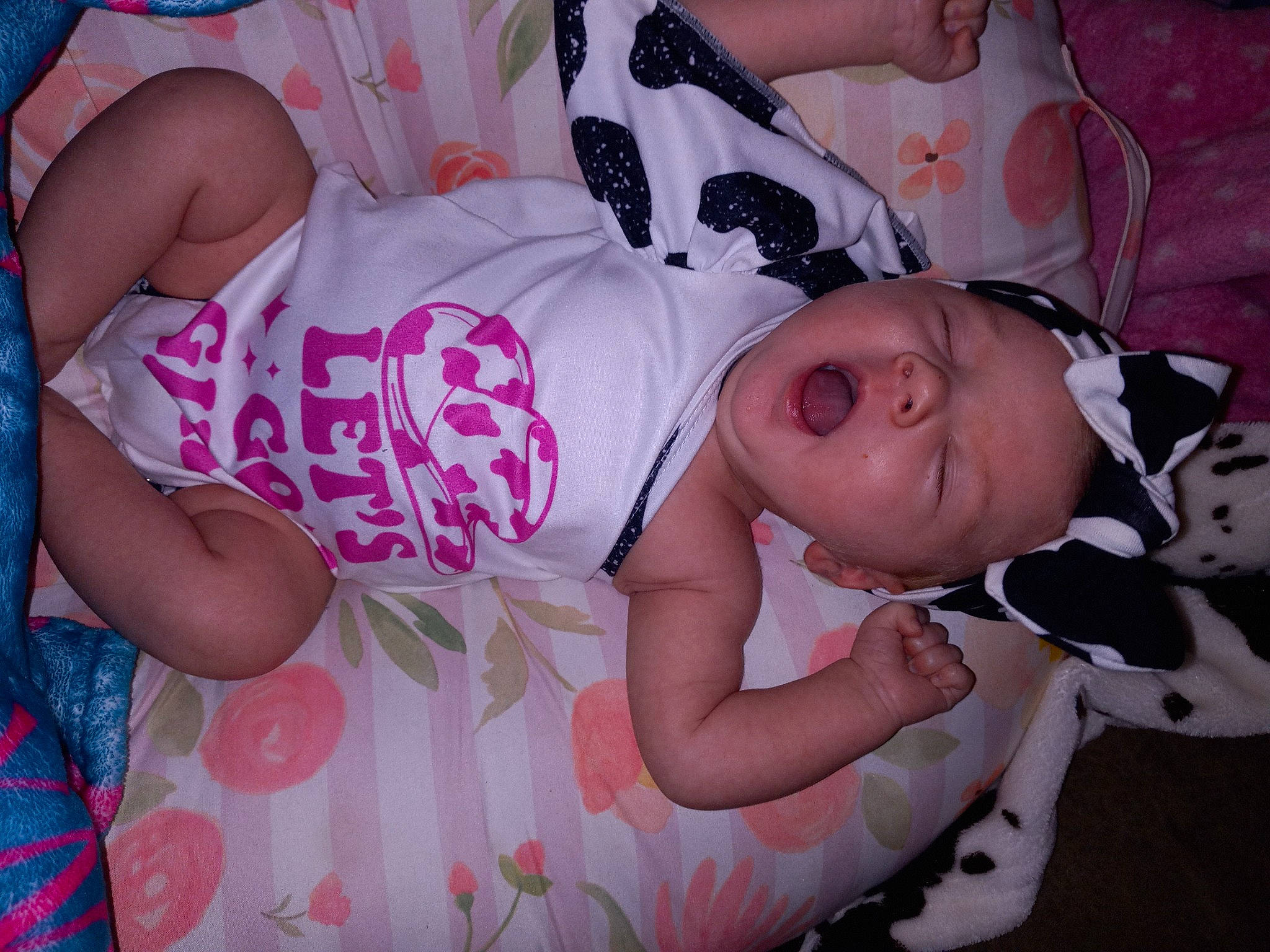 Dynver is registered to the contest to win money with this photo: baby, baby_products, baby_toddler_clothing, cheek, child, comfort, eye, happy, human_leg, linens, magenta, mammal, pattern, person, pink, room, sleep, sleeve, thigh, toddler