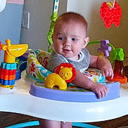 Everett joined the competition — help win amazing prizes! activity_center, baby, child, clothing, colorful, cute, engaged, floor, furniture, giraffe_toy, home, indoor, infant, lion_toy, person, play, red_butterfly_toy, smiling, toys, wooden_floor