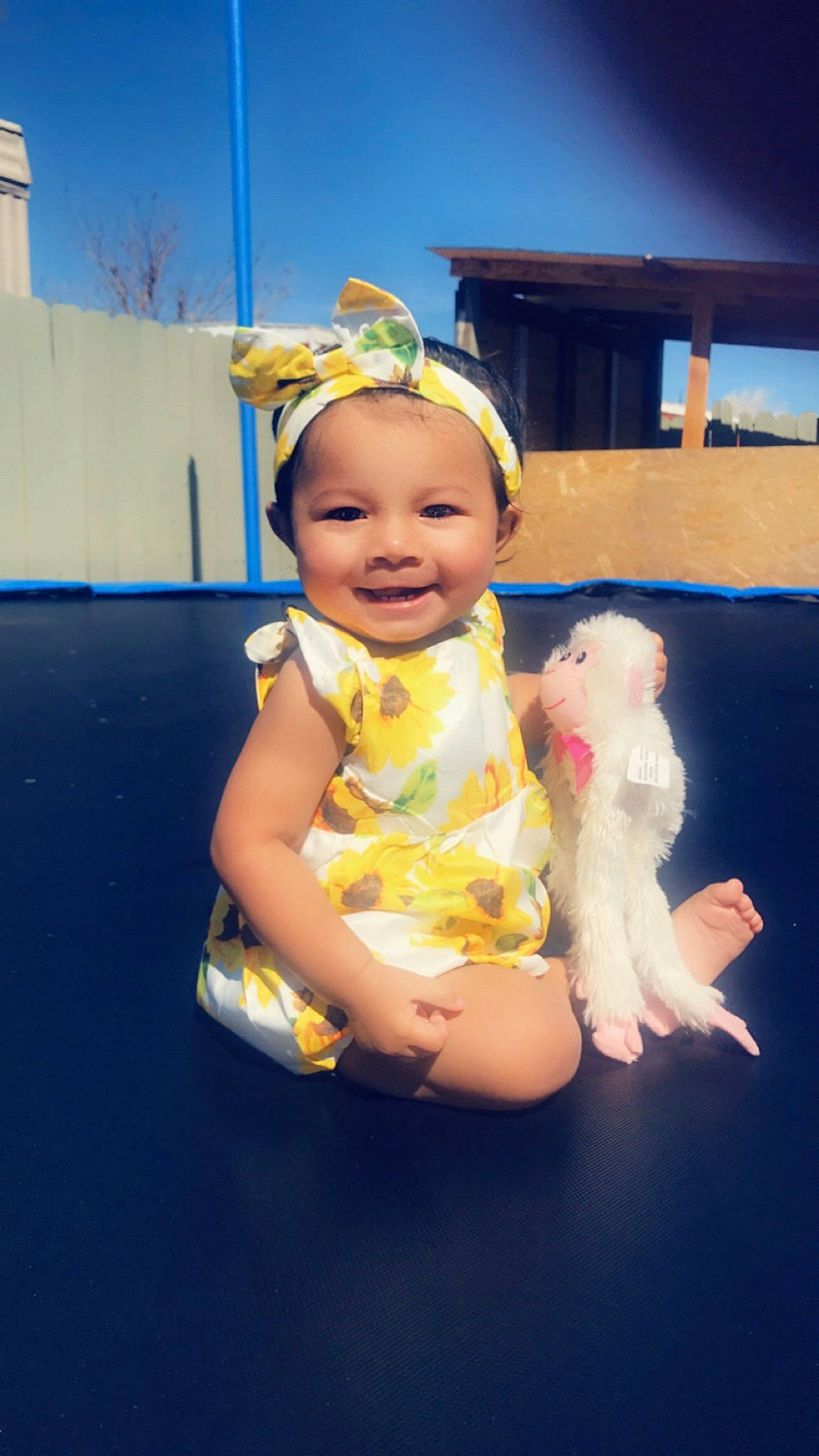 Carla is registered to the contest to win money with this photo: abdomen, baby, baby_toddler_clothing, child, companion_dog, event, fashion_accessory, flash_photography, fun, fur, happy, hat, joy, leisure, person, sitting, skin, sky, smile, sun_hat