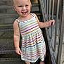 Elisia is registered to the contest to win money with this photo: toddler, child, smiling, barefoot, striped_dress, metal_stairs, railing, outdoor, happy, person, portrait, young_child, cute, standing, summer_clothing, daylight, skin, hair, feet, holding