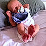 baby, sleeping, pacifier, pillow, bed, white_sheet, infant, newborn, feet, hands, clothing, blanket, peaceful, cute, indoors, person, resting, soft_light, closeup, relaxation