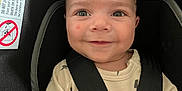 Brian is registered to the contest to win money with this photo: baby, child, car_seat, safety_harness, onesie, lightning_bolt_pattern, smile, face, infant, cute, straps, seat, child_safety, young, happy, indoors, portrait, person, clothing, head