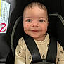 Brian is registered to the contest to win money with this photo: baby, child, car_seat, safety_harness, onesie, lightning_bolt_pattern, smile, face, infant, cute, straps, seat, child_safety, young, happy, indoors, portrait, person, clothing, head