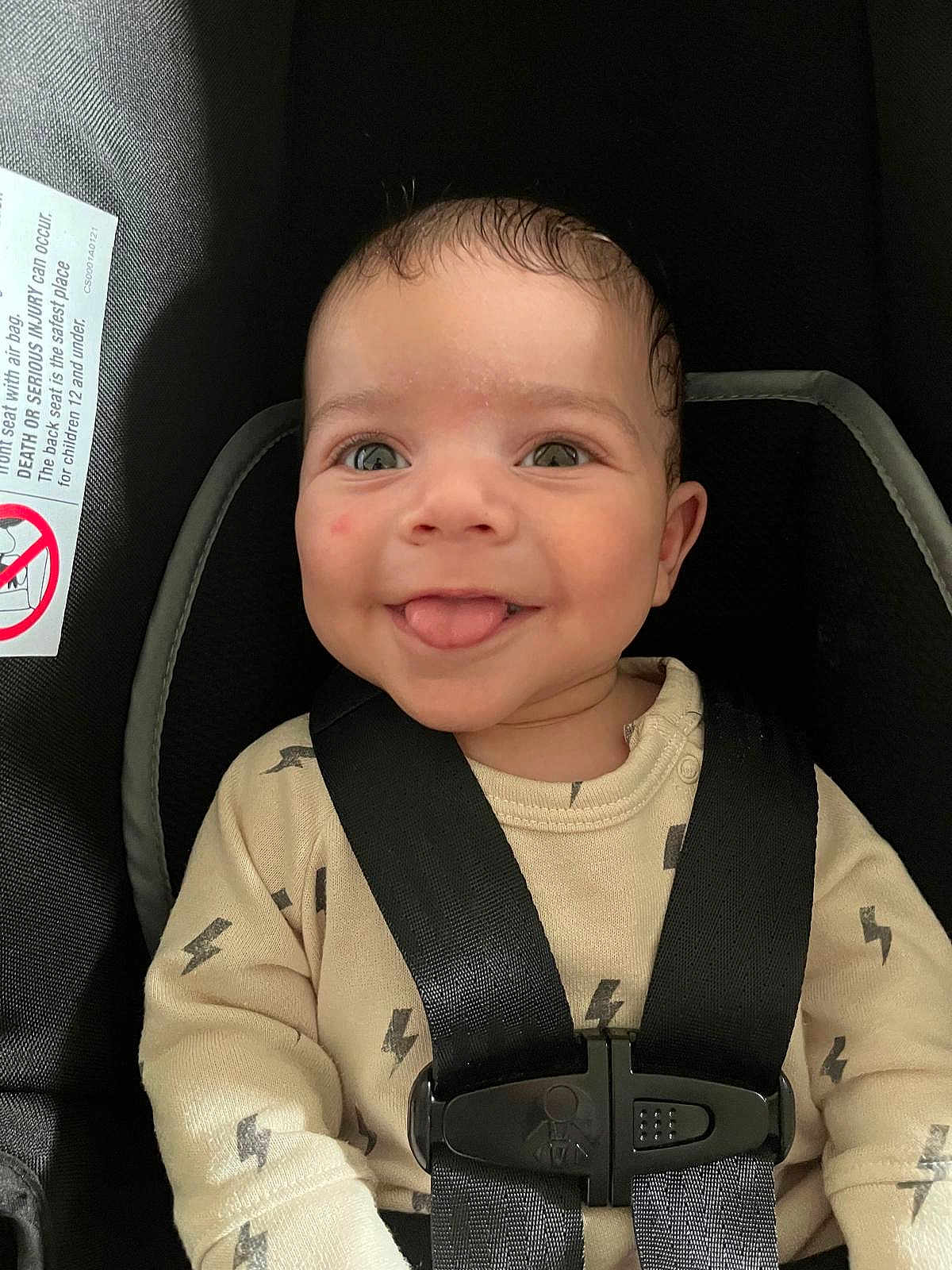 Brian joined the competition — help win amazing prizes! baby, child, smiling, tongue_out, car_seat, safety_harness, clothing, lightning_pattern, cute, infant, seatbelt, portrait, indoors, face, happy, young_child, seat, straps, closeup, person