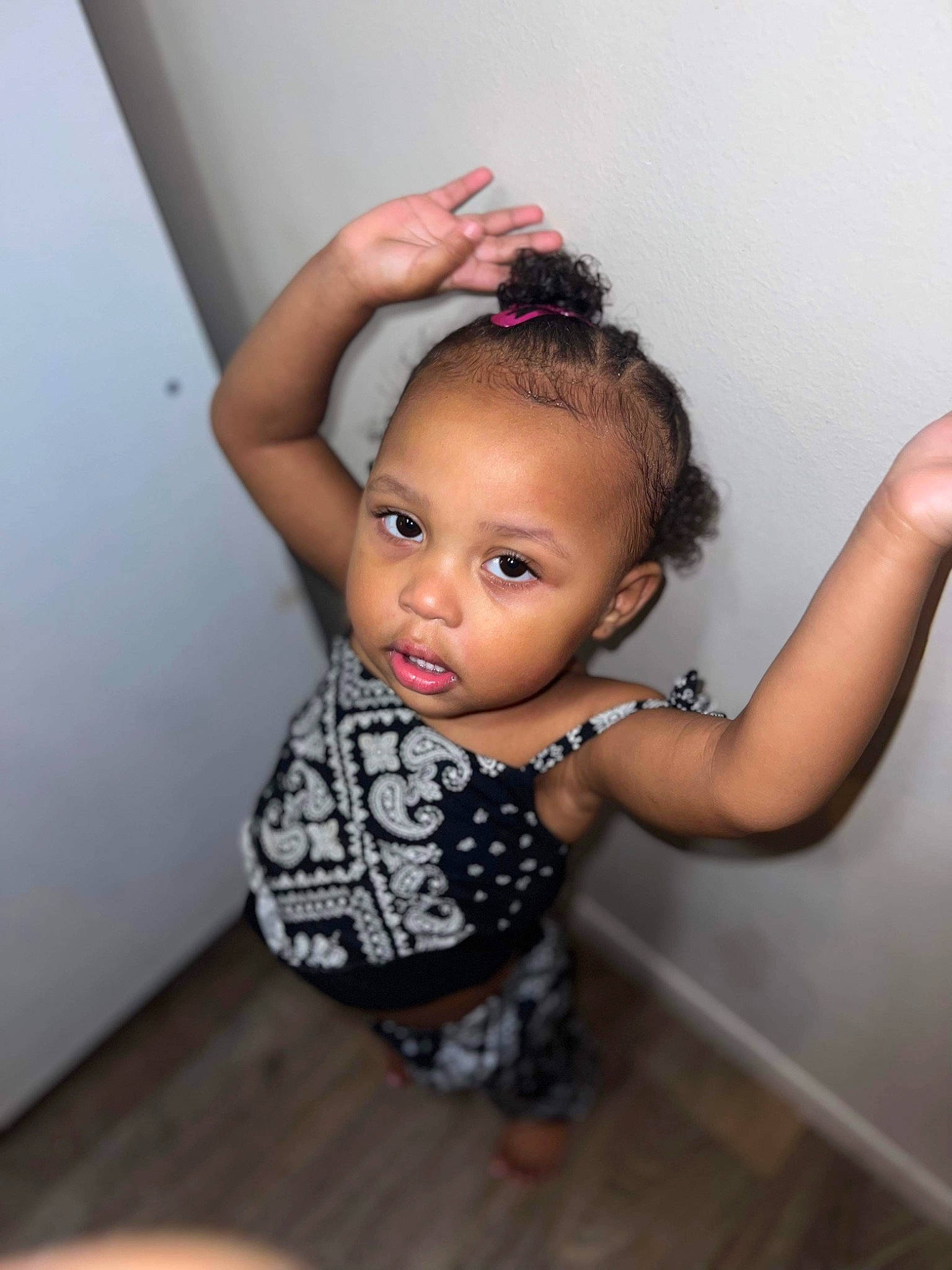 Iris is registered to the contest to win money with this photo: baby_toddler_clothing, black_hair, cheek, dress, elbow, eyelash, fashion_design, flash_photography, flooring, gesture, happy, hardwood, human_leg, lip, neck, nose, person, skin, toddler, wood