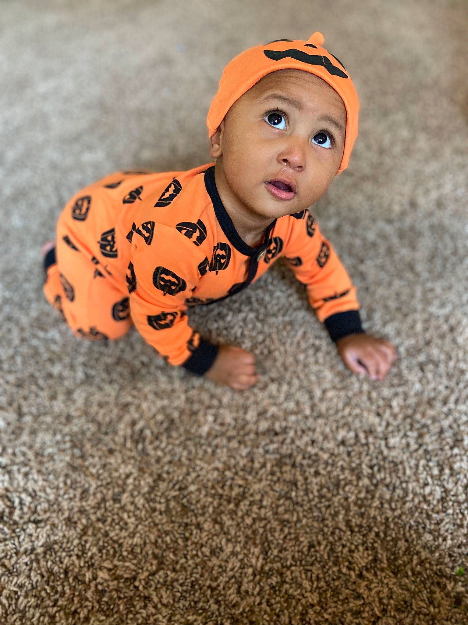 Damarious is registered to the contest to win money with this photo: baby, baby_toddler_clothing, carmine, child, crawling, flooring, fun, grass, happy, headwear, orange, pattern, person, portrait_photography, shadow, sitting, sleeve, surprise, toddler, tree