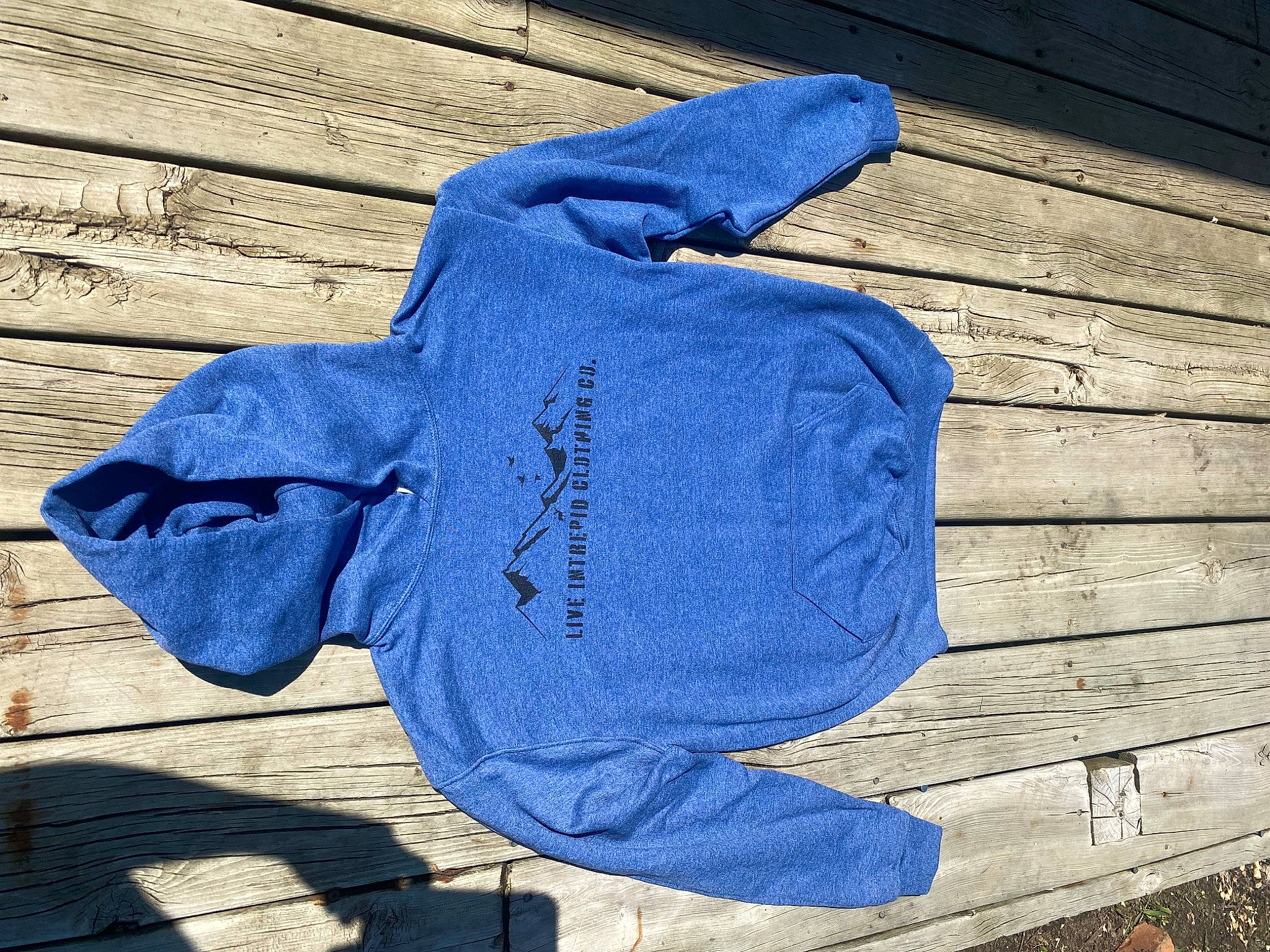 Hazel is registered to the contest to win money with this photo: azure, blue, cap, carmine, denim, electric_blue, flooring, font, glove, grey, hat, headgear, outerwear, person, personal_protective_equipment, sleeve, sportswear, t_shirt, wall, wood