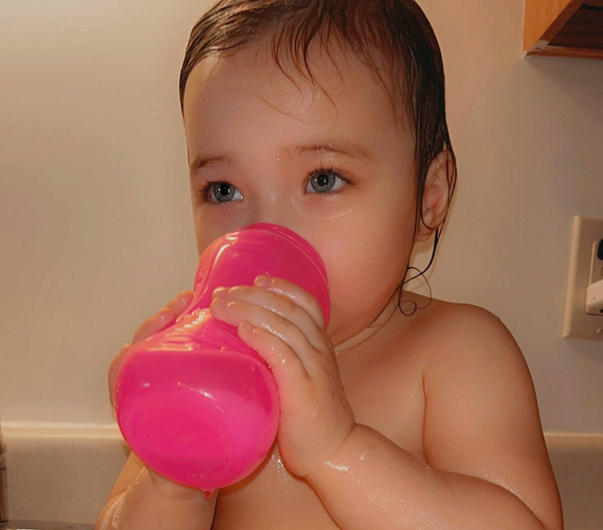 Azalea is registered to the contest to win money with this photo: arm, baby, baby_bottle, cheek, chest, drinkware, ear, eyelash, face, fun, gesture, hand, human_body, lip, nail, nose, person, plastic_bottle, skin, thumb