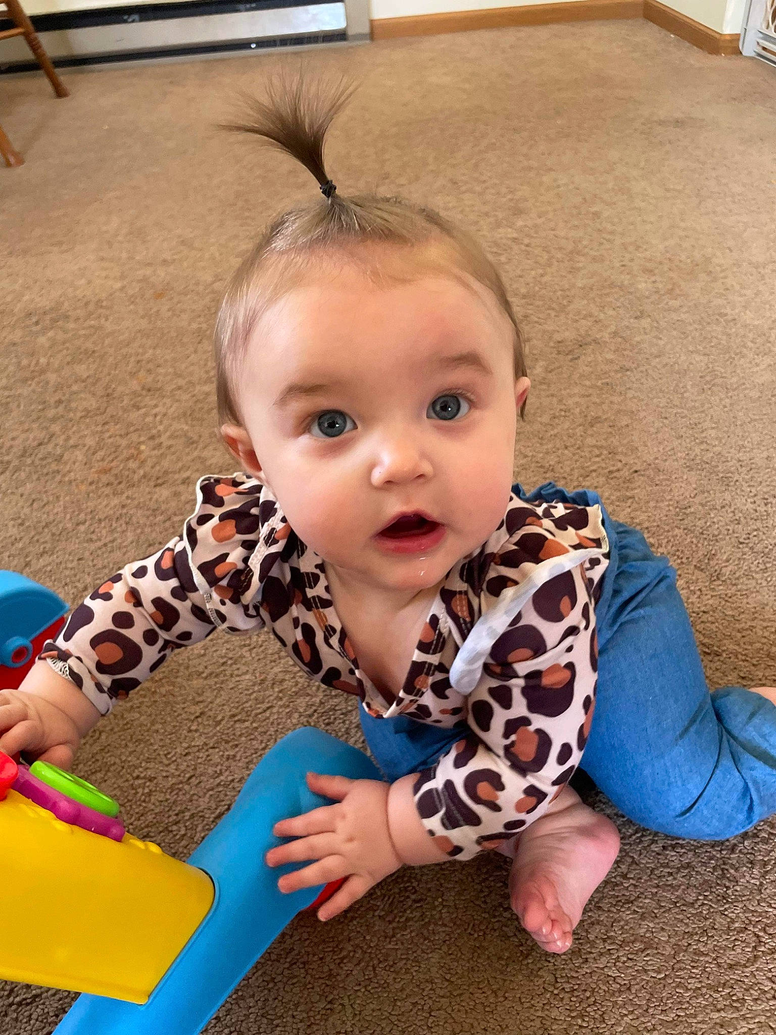 Amelia is registered to the contest to win money with this photo: baby, baby_playing_with_toys, baby_toddler_clothing, cheek, child, ear, eyelash, flooring, fun, grass, happy, human_body, iris, leisure, person, photograph, sitting, skin, snapshot, surprise