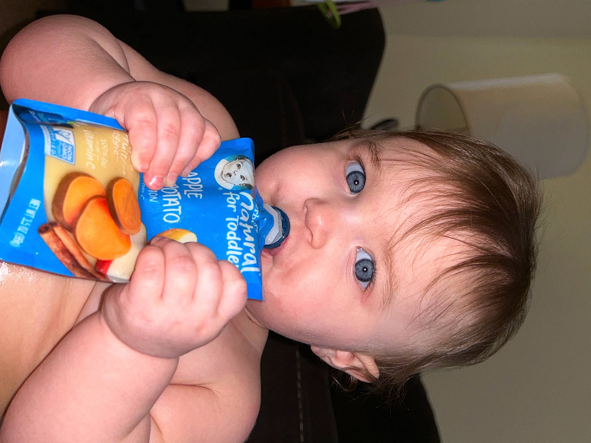 Amelia is registered to the contest to win money with this photo: baby, baby_toddler_clothing, cheek, child, drinkware, eyelash, finger, fun, gesture, hand, happy, iris, mouth, nail, nose, person, plastic_bottle, skin, thumb, toddler