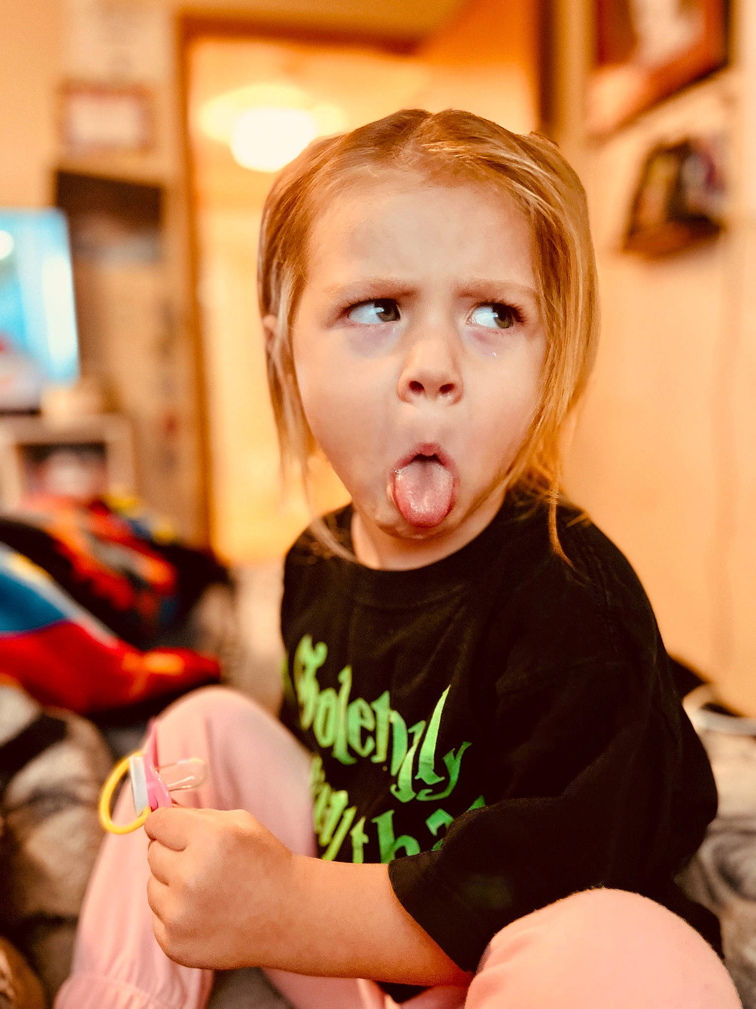 Maya is registered to the contest to win money with this photo: baby, baby_toddler_clothing, blond, cheek, child, chin, finger, fun, happy, person, picture_frame, play, portrait_photography, room, sitting, skin, sleeve, surprise, t_shirt, toddler