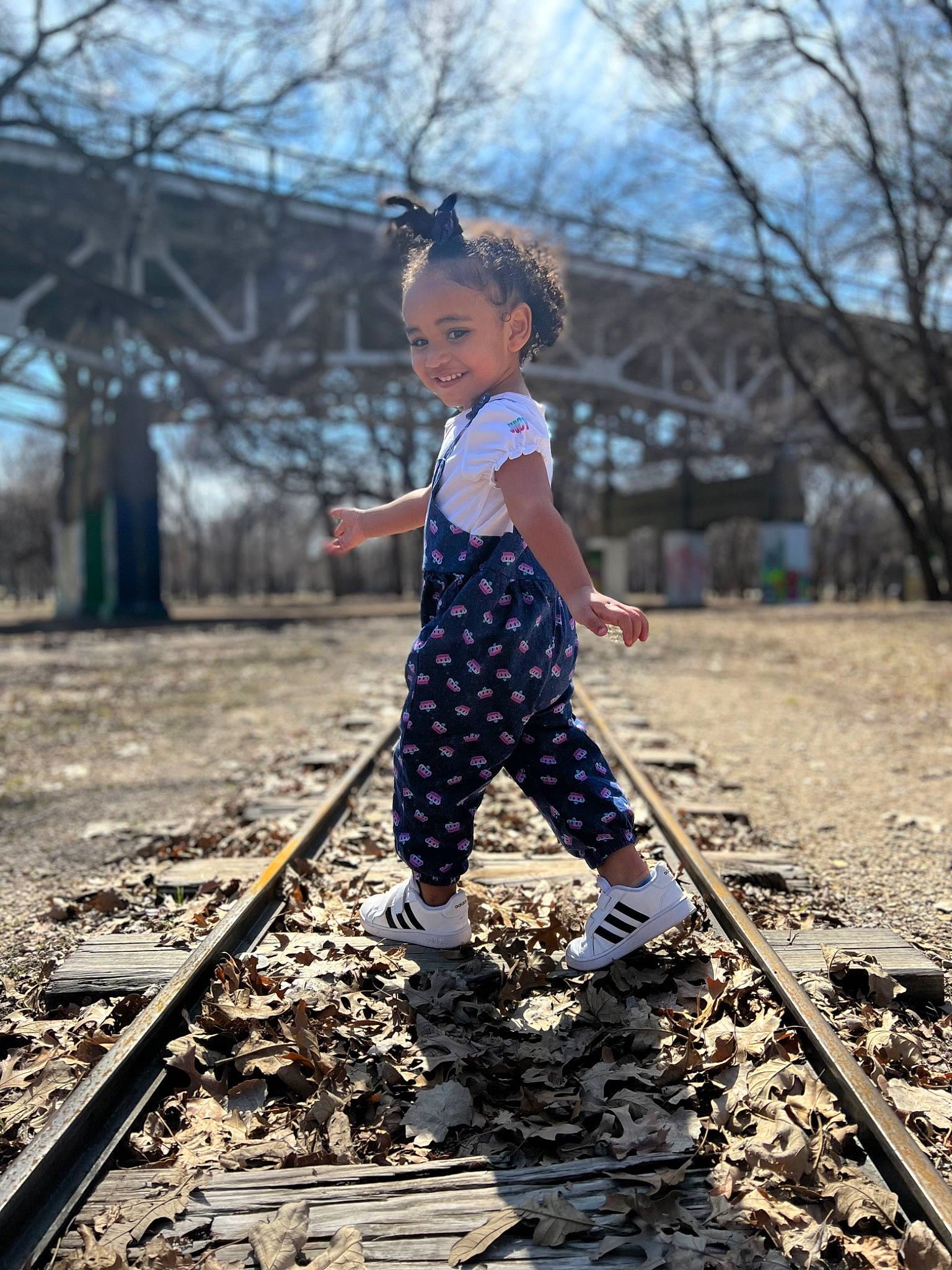 Ilani joined the competition — help win amazing prizes! bridge, child, dress, fun, grass, happy, joy, leisure, pattern, people_in_nature, person, plant, public_space, rolling, sky, sneakers, sunlight, tints_and_shades, toddler, track