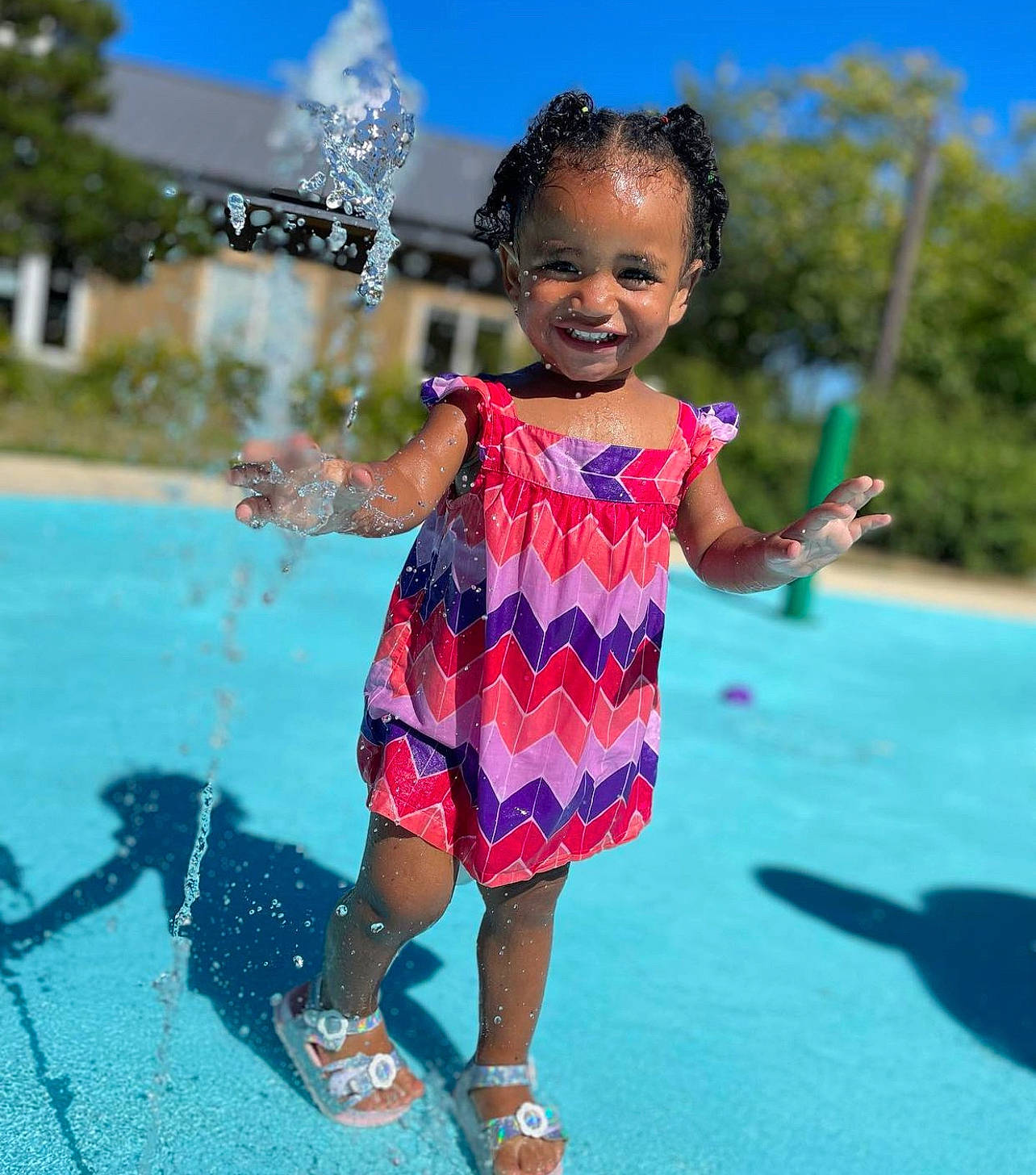 Ilani joined the competition — help win amazing prizes! aqua, baby_toddler_clothing, cool, electric_blue, fountain, fun, gesture, grass, happy, joy, leaf, leisure, people_in_nature, person, pink, recreation, sky, smile, snapshot, standing