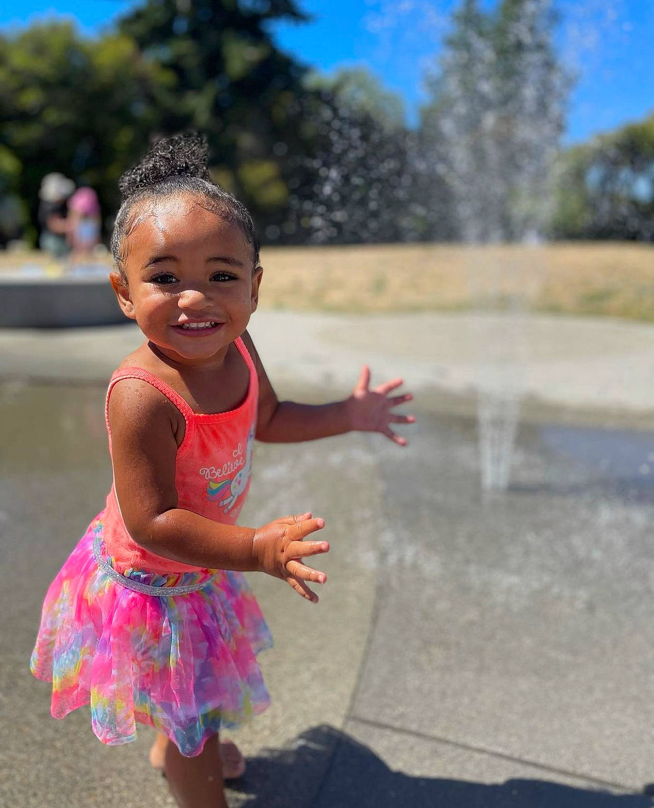 Ilani is registered to the contest to win money with this photo: asphalt, child, facial_expression, fun, gesture, grass, happy, joy, leisure, morning, person, pink, recreation, road, skin, sky, smile, standing, toddler, travel