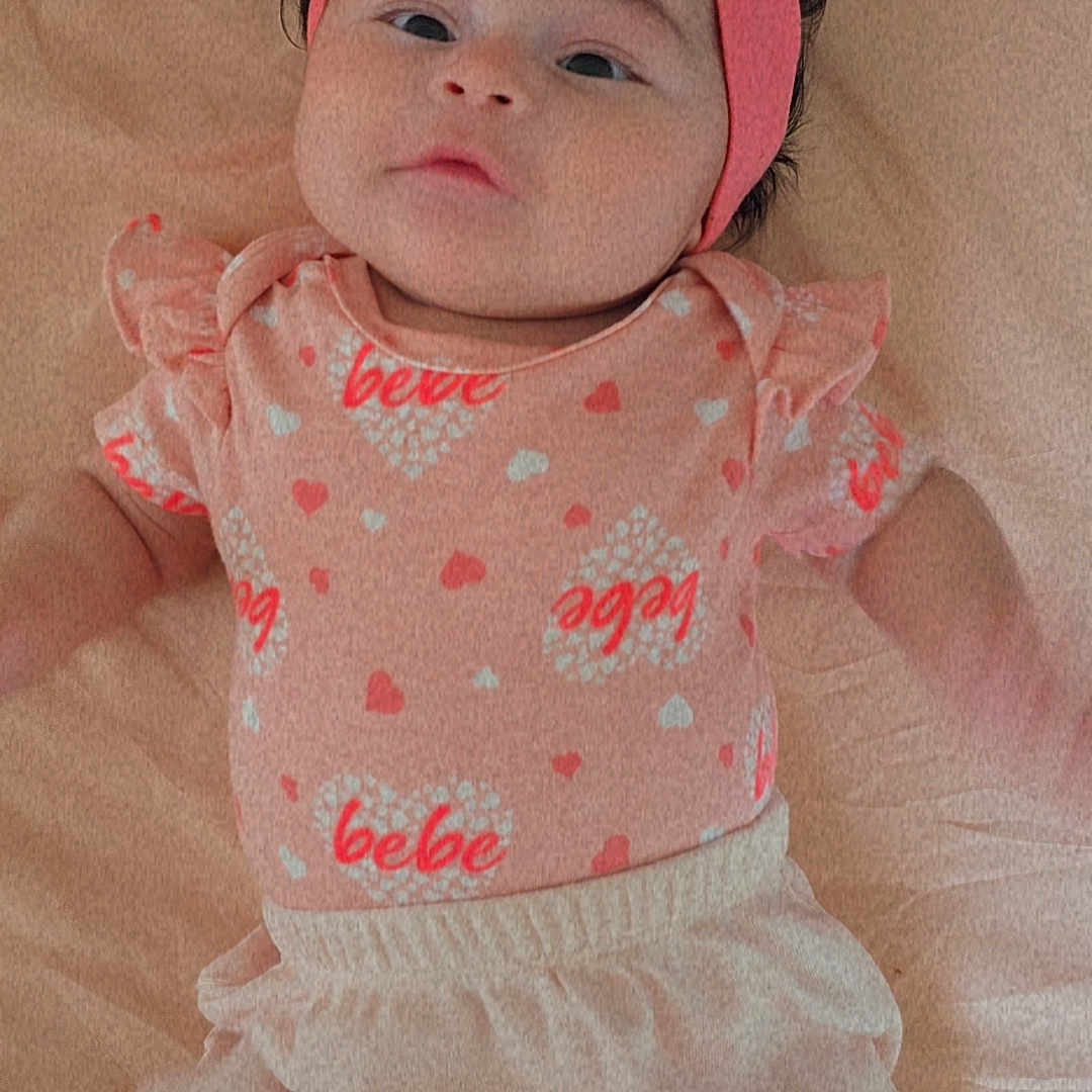 Kamyah is registered to the contest to win money with this photo: adorable, baby, blanket, casual_clothing, child, clothing, cute, fashion, flower, headband, heart_pattern, indoor, infant, lying_down, person, pink, portrait, small_child, soft_texture, young_child