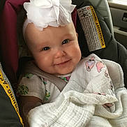 Ava joined the competition — help win amazing prizes! baby, car_seat, blanket, headband, smile, infant, child, seatbelt, cute, indoors, car, clothing, white_flower, happy, portrait, baby_girl, soft_lighting, comfortable, wrapped, seat