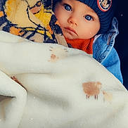 Noah a rejoint le concours — aidez-le/la à gagner de superbes lots ! baby, child, blanket, beanie, hat, mickey_mouse, blue_eyes, coat, denim_jacket, warm_clothing, portrait, face, cute, infant, cozy, soft_texture, indoor, closeup, expression, wrapped