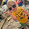 Braxley is registered to the contest to win money with this photo: blanket, carpet, casual, child, cute, fashion, happy, home, indoor, laundry_basket, person, playroom, shoes, shorts, smile, sunglasses, toddler, toy, yellow_shirt, young_child