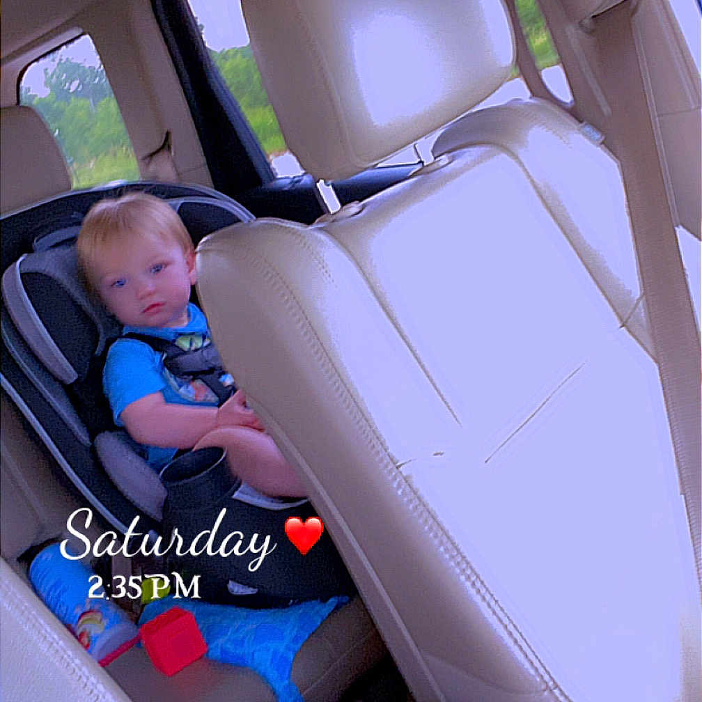 Braxley joined the competition — help win amazing prizes! toddler, child, car_seat, car_interior, beige_seat, toy, window, seat_belt, blue_shirt, daytime, vehicle, rear_seat, child_safety, car, baby, person, seat_headrest, indoor, seat_back, child_toy