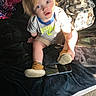 Braxley joined the competition — help win amazing prizes! toddler, child, bed, blanket, tablet, shoe, indoor, curious, blue_eyes, casual_clothing, sunlight, carpet, footwear, person, clothing, hair, sitting, home, technology, playful