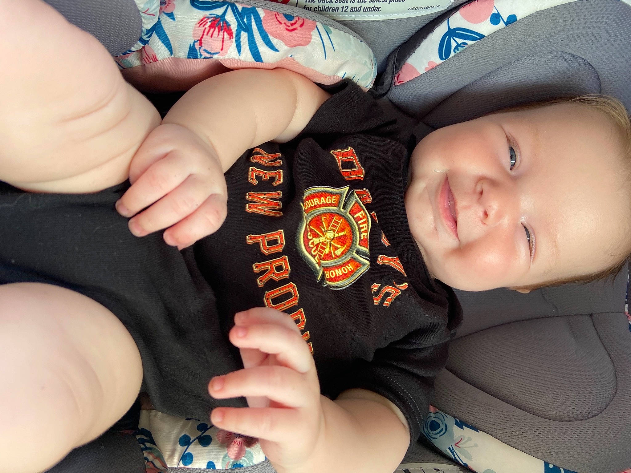 Lorelei is registered to the contest to win money with this photo: baby_in_car_seat, baby_toddler_clothing, blue, cap, carmine, cheek, comfort, elbow, finger, fun, gesture, hand, happy, joy, nail, person, sleeve, smile, steering_wheel, thumb