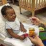Roy joined the competition — help win amazing prizes! baby, baby_food, bib, carpet, child, clothing, crib, feeding, feeding_time, floor, hand, happy, high_chair, indoor, infant, nursery, person, smiling, spoon, tattoo