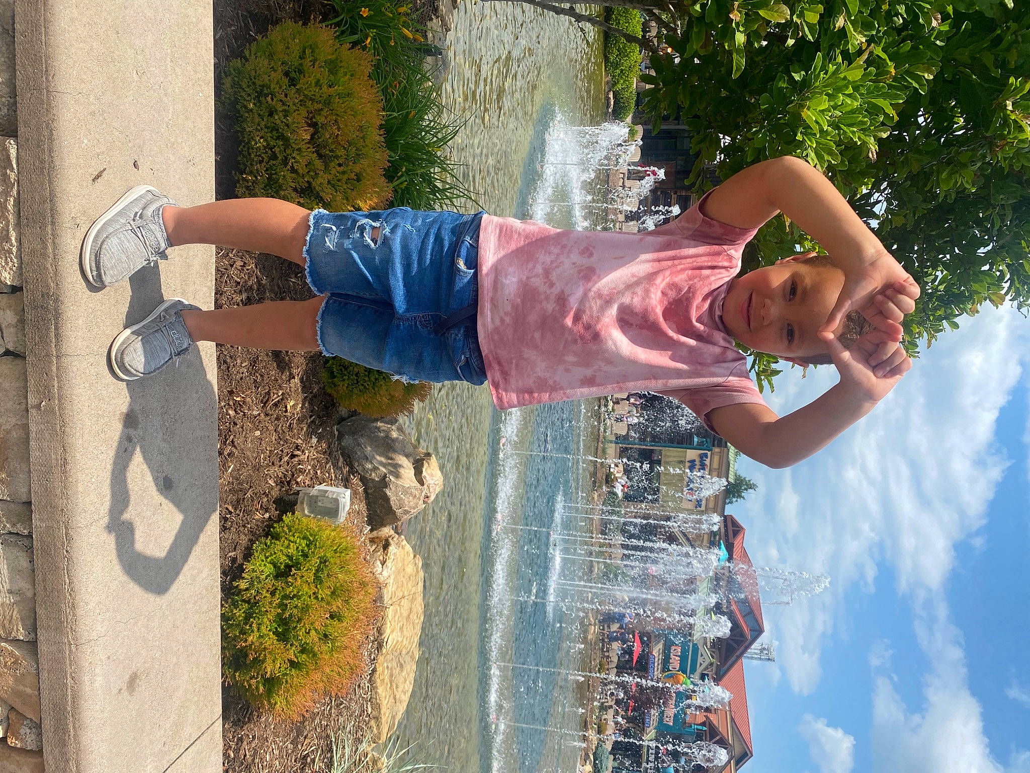 Jayce is registered to the contest to win money with this photo: concrete, denim, elbow, fun, gesture, happy, human_leg, joy, leisure, people_in_nature, person, plant, recreation, sky, t_shirt, travel, tree, vacation, waist, water