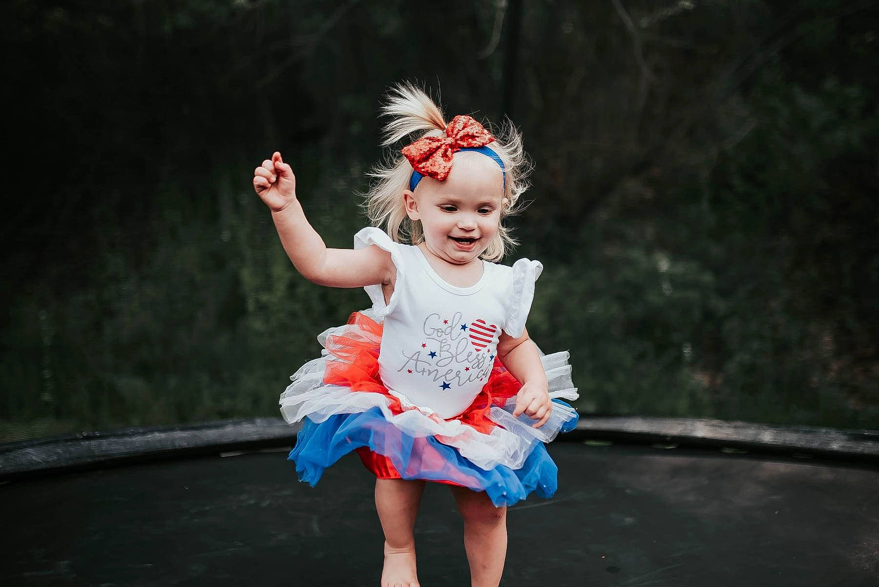 Delaney is registered to the contest to win money with this photo: ballet_tutu, child, dress, entertainment, event, face, fashion_design, flash_photography, fun, grass, hair, happy, head, headgear, headpiece, headwear, joy, performing_arts, person, pink