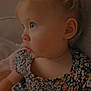 Lana is registered to the contest to win money with this photo: toddler, child, portrait, side_view, blonde_hair, blue_eyes, floral_dress, cute, indoors, soft_lighting, curious, sitting, young_child, small_pony_tail, person, face, baby, clothing, warm_colors, cozy