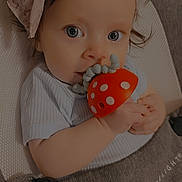 Kaylie joined the competition — help win amazing prizes! baby, baby_carrier, chewing, child, closeup, clothing, comfort, cute, eyes, fabric, face, hand, headband, indoor, infant, mushroom, polka_dot, portrait, soft_texture, toy