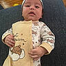 Mateo is registered to the contest to win money with this photo: baby, child, clothing, comfort, couch, cute, expression, face, hand, headband, home, indoors, infant, onesie, portrait, relaxing, sitting, teddy_bear_pattern, wooden_floor, young_child